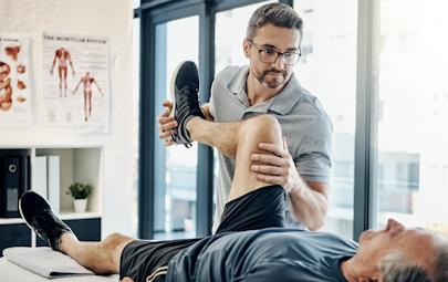 Physical therapist working with patient in a clinical environment/facility Physical therapist working with patient in a clinical environment/facility