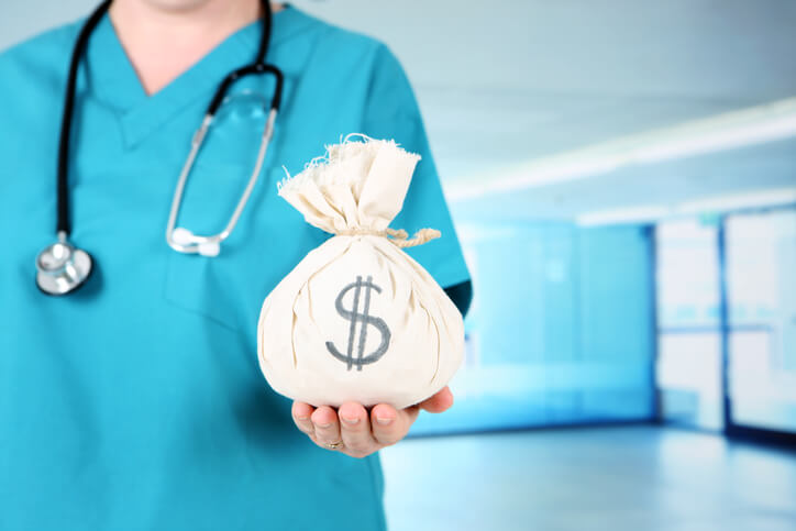 nurse in hospital holding money bag