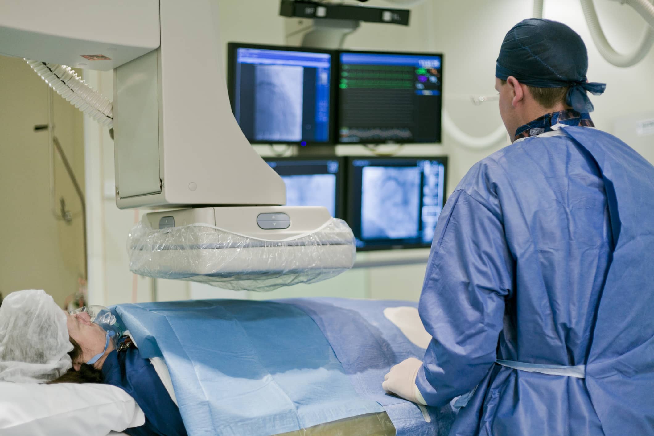 Cath lab tech working in a medical environment Cath lab tech working in a medical environment