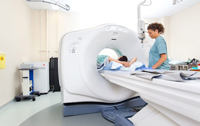 MRI Tech working with a patient during a scan MRI Tech working with a patient during a scan