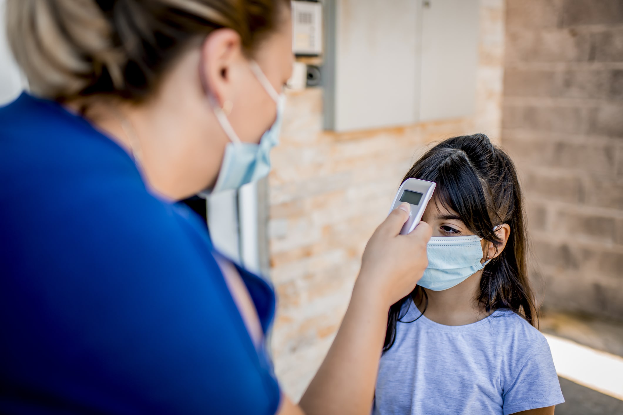 School nurse checking student's temperature