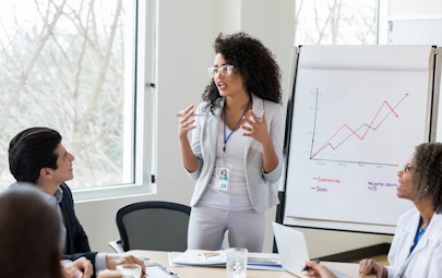 a woman presenting to colleagues a woman presenting to colleagues