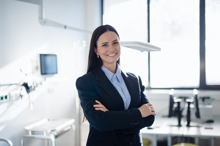 Healthcare Executive Standing in a Medical Facility