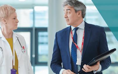 Healthcare leaders talking in the halls of a hosptial. Healthcare leaders talking in the halls of a hosptial.