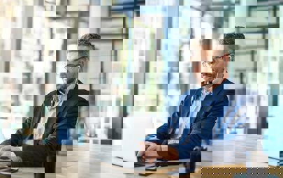 businessman listening to podcast on laptop businessman listening to podcast on laptop