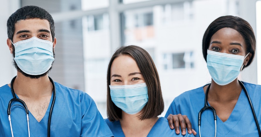 three nurses with scrubs and face masks