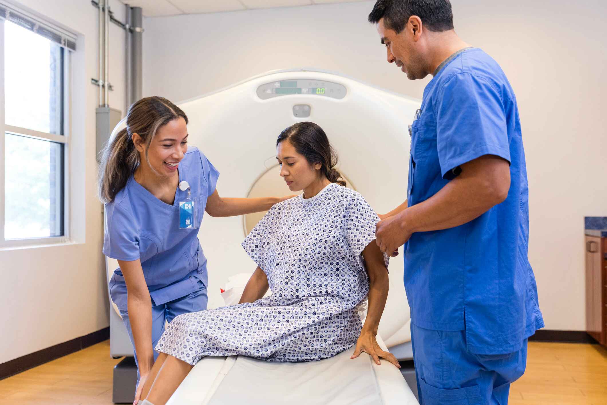 CT tech helping a patient out of the scanner CT tech helping a patient out of the scanner
