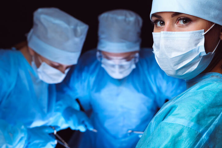 Nurses wearing masks working on a patient