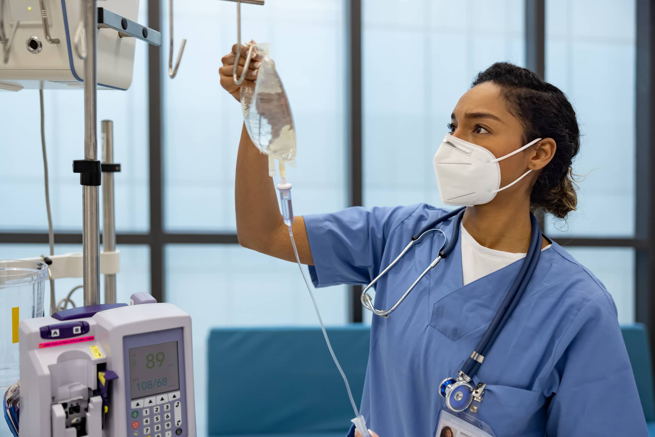 Emergency Room Nurse Hanging IV Bag