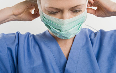 Nurse putting on mask Nurse putting on mask