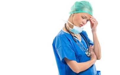 Nurse in scrubs looking tired and upset Nurse in scrubs looking tired and upset
