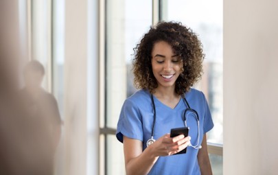 Travel Nurse Checking Her Pay on Her Phone Travel Nurse Checking Her Pay on Her Phone