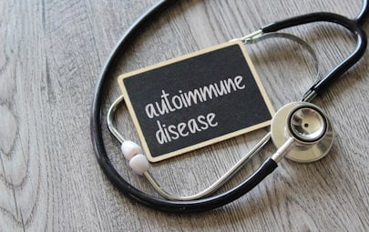 Stethoscope wrapped around a sign that says Autoimmune Disease. Stethoscope wrapped around a sign that says Autoimmune Disease.