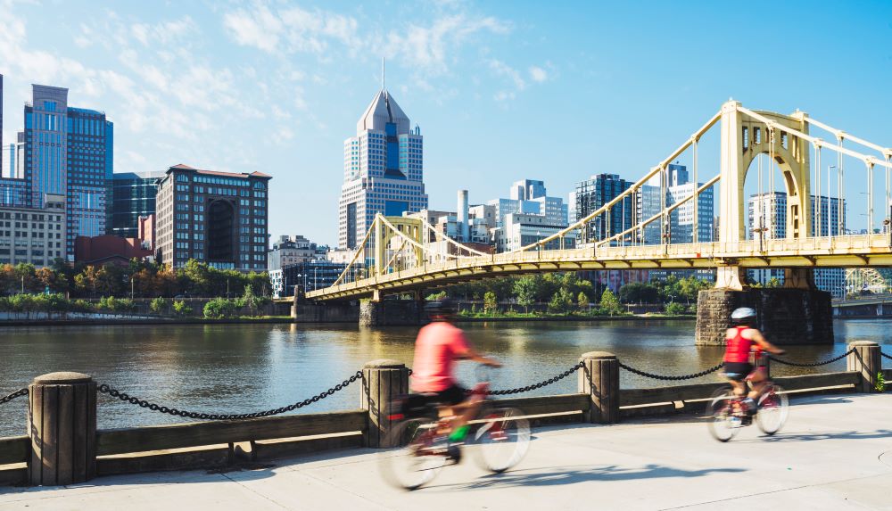 people riding bikes near a bridge