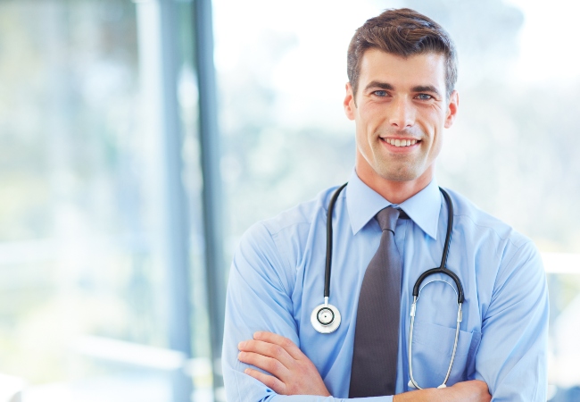 Doctor standing with arms crossed Doctor standing with arms crossed