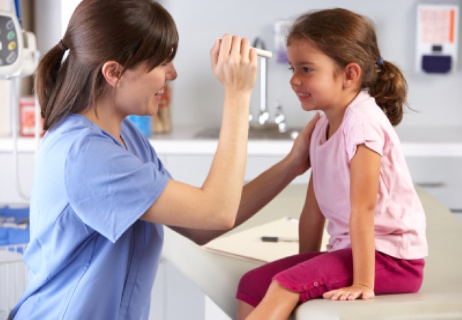 Pediatric Nurse sitting with patient Pediatric Nurse sitting with patient