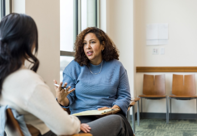 Therapist speaking with female patient Therapist speaking with female patient