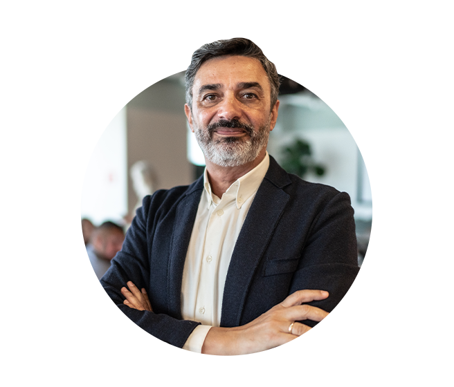 Male executive of company standing arms crossed. 