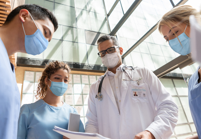 Locum tenens physician speaking to medical team Locum tenens physician speaking to medical team