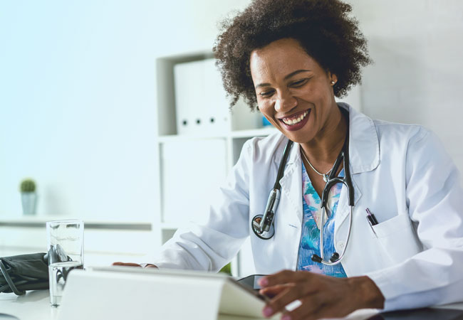 Female physician using tablet computer Female physician using tablet computer