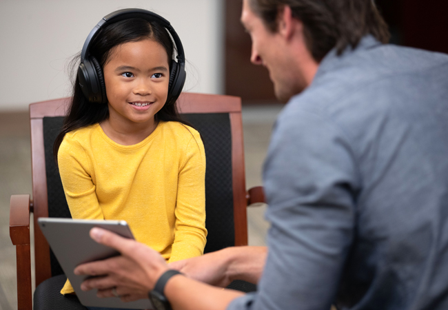 Male language interpreter showing female child table computer
